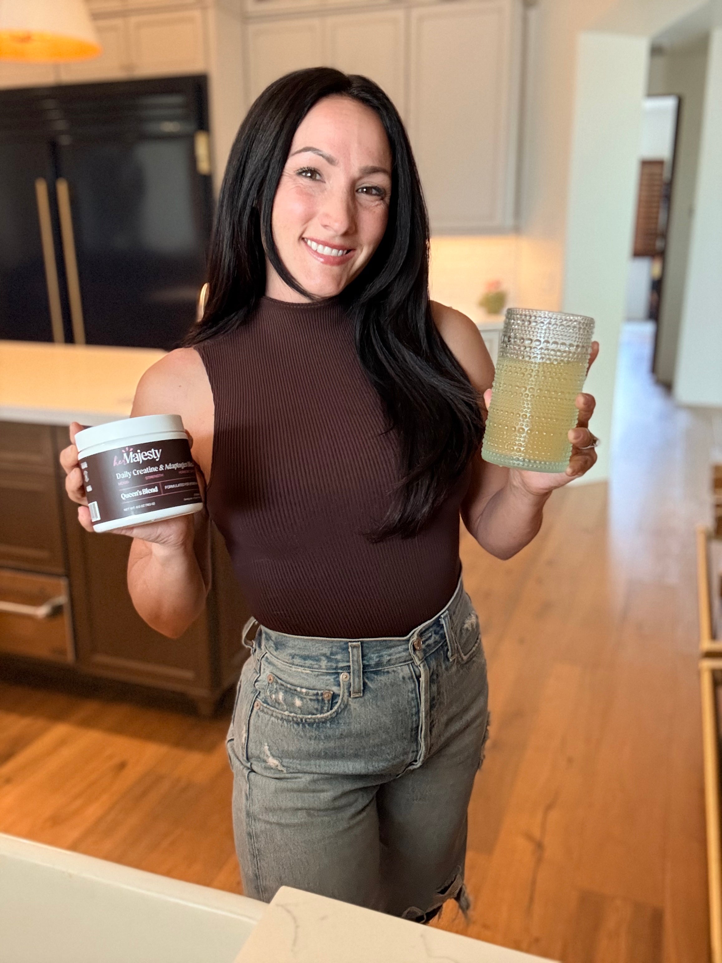 Samantha Prestenbach holding Queen's Blend jar and glass